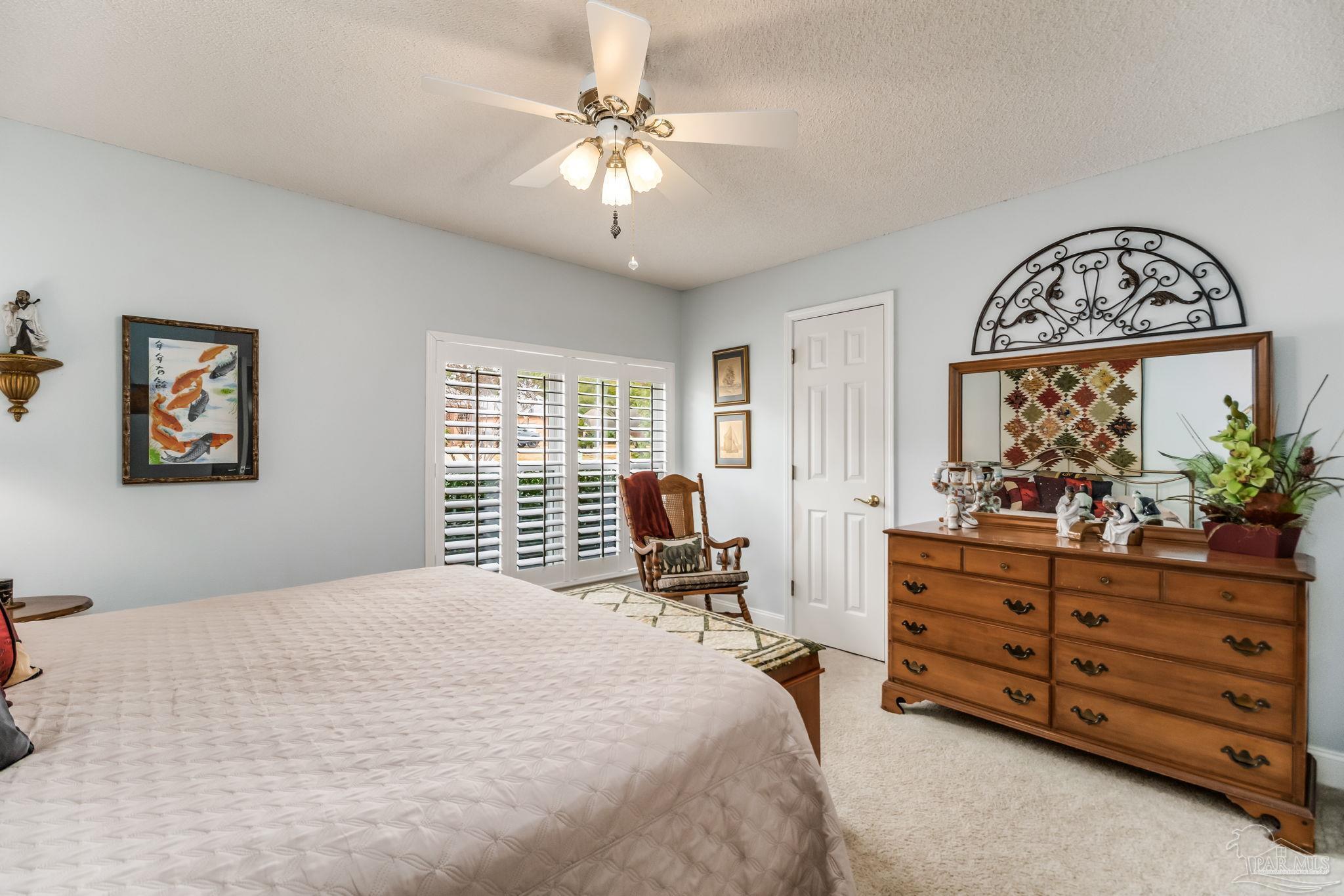 3106 Cobblestone Drive Pace, FL 32571 - Photo 32 of 61 a bedroom with a bed and a dresser in it
