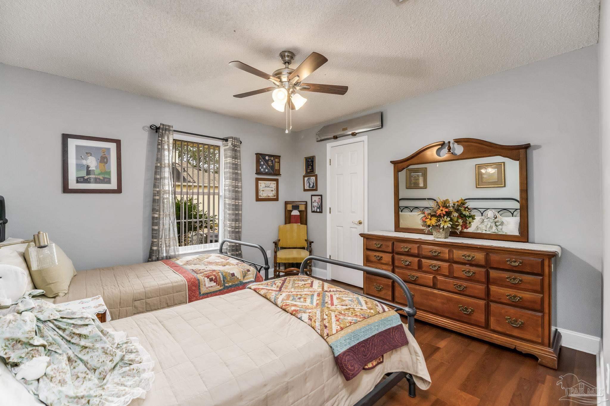 3106 Cobblestone Drive Pace, FL 32571 - Photo 33 of 61 a bedroom with two beds and a chandelier