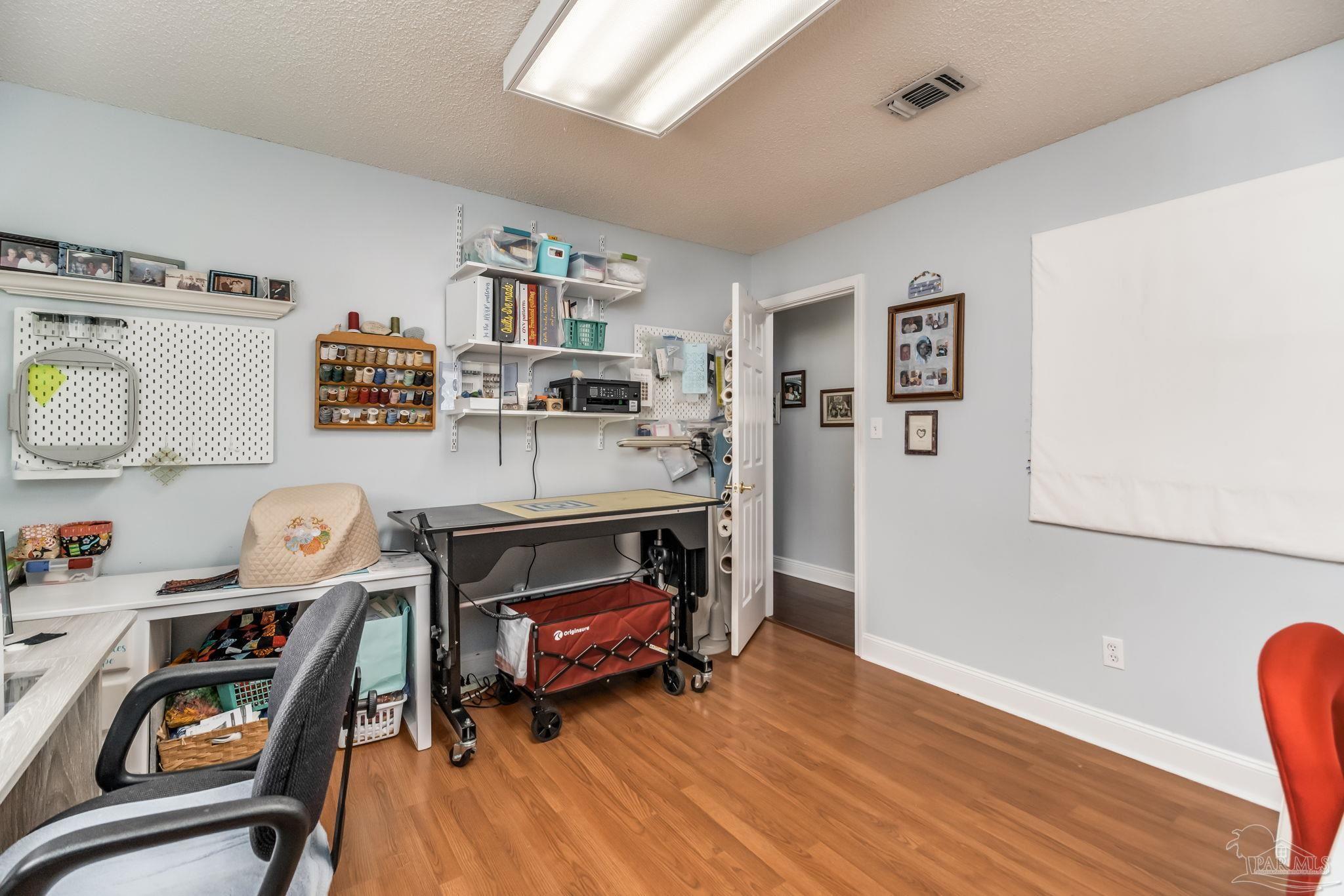 3106 Cobblestone Drive Pace, FL 32571 - Photo 40 of 61 a view of a workspace with furniture and wooden floor