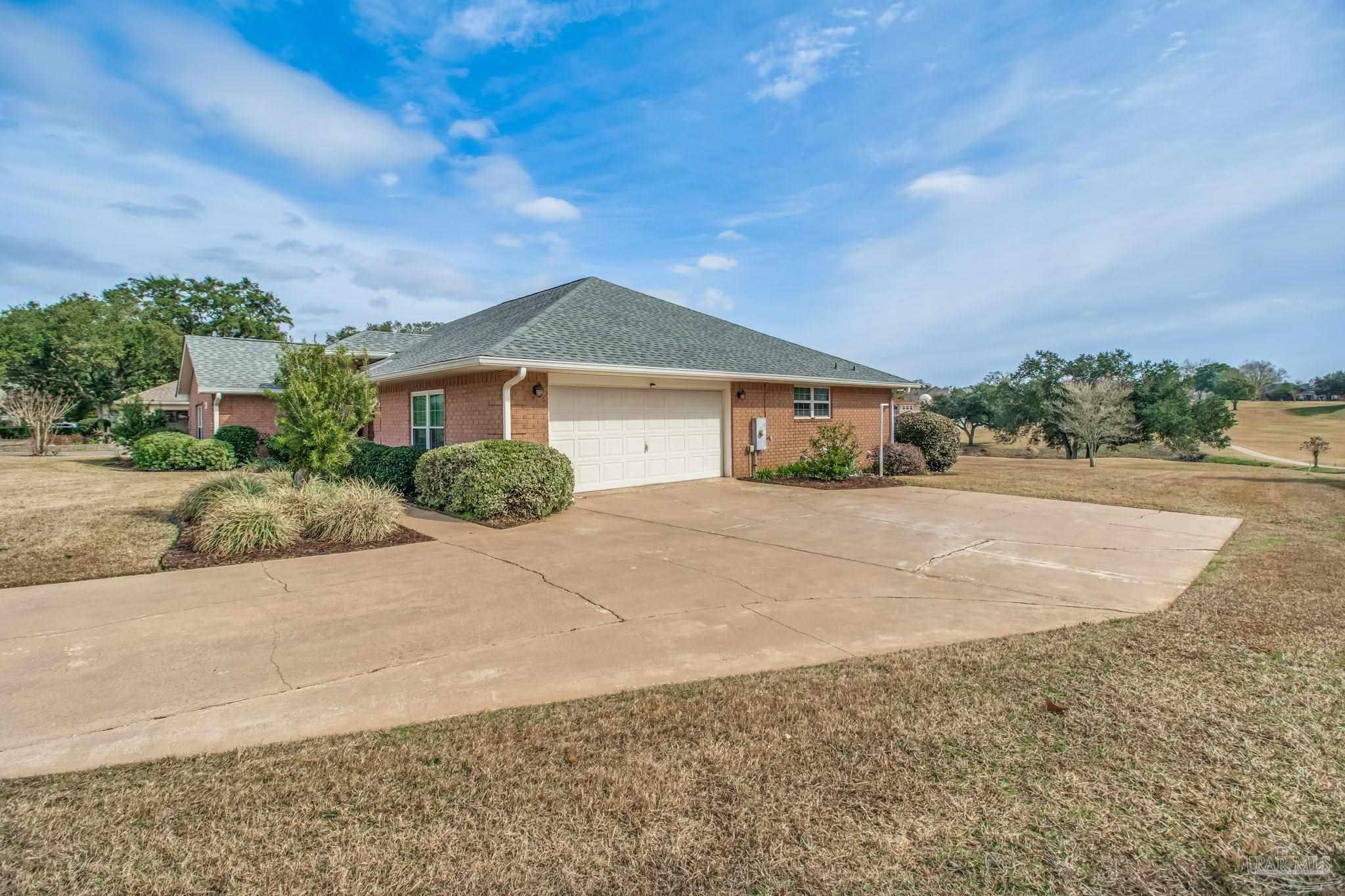 3106 Cobblestone Drive Pace, FL 32571 - Photo 50 of 61 a front view of a house with a yard and garage