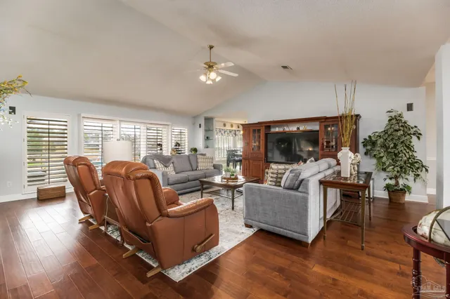 a view of a dining room with furniture and wooden floor