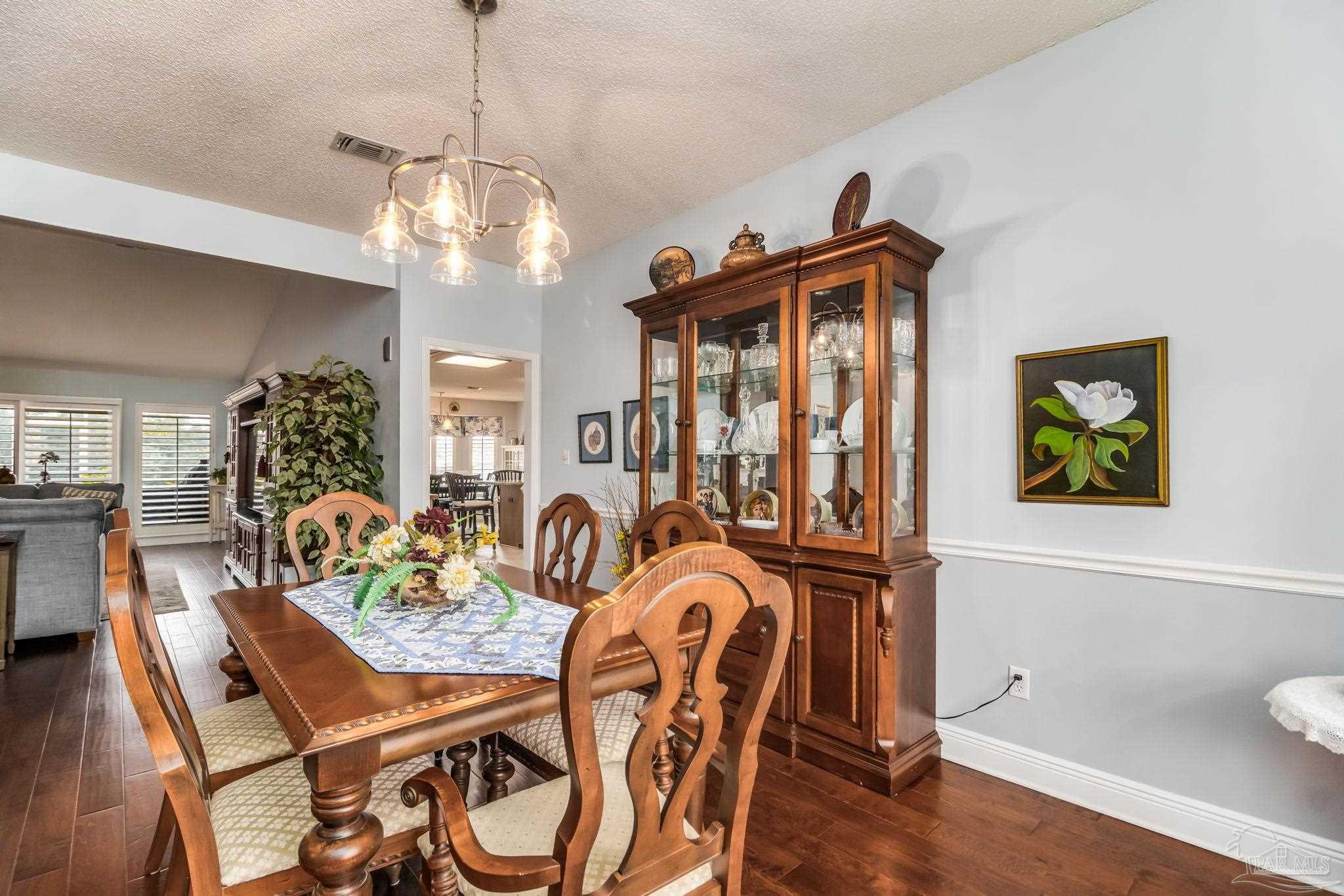 3106 Cobblestone Drive Pace, FL 32571 - Photo 6 of 61 a view of a dining room with furniture and wooden floor