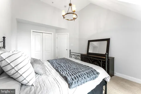 a bedroom with a bed and dresser