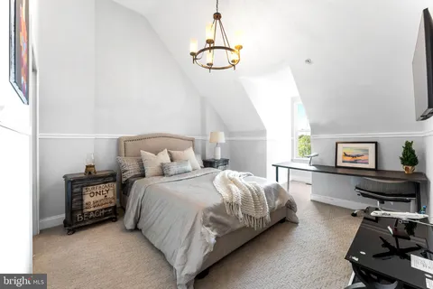 a bedroom with a bed a desk and chair