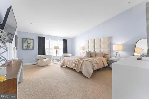 a spacious bedroom with a bed and a couch