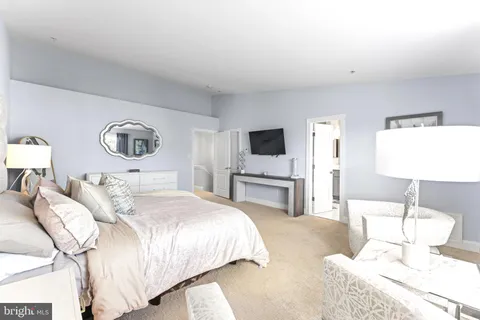 a bedroom with a bed and a lamp