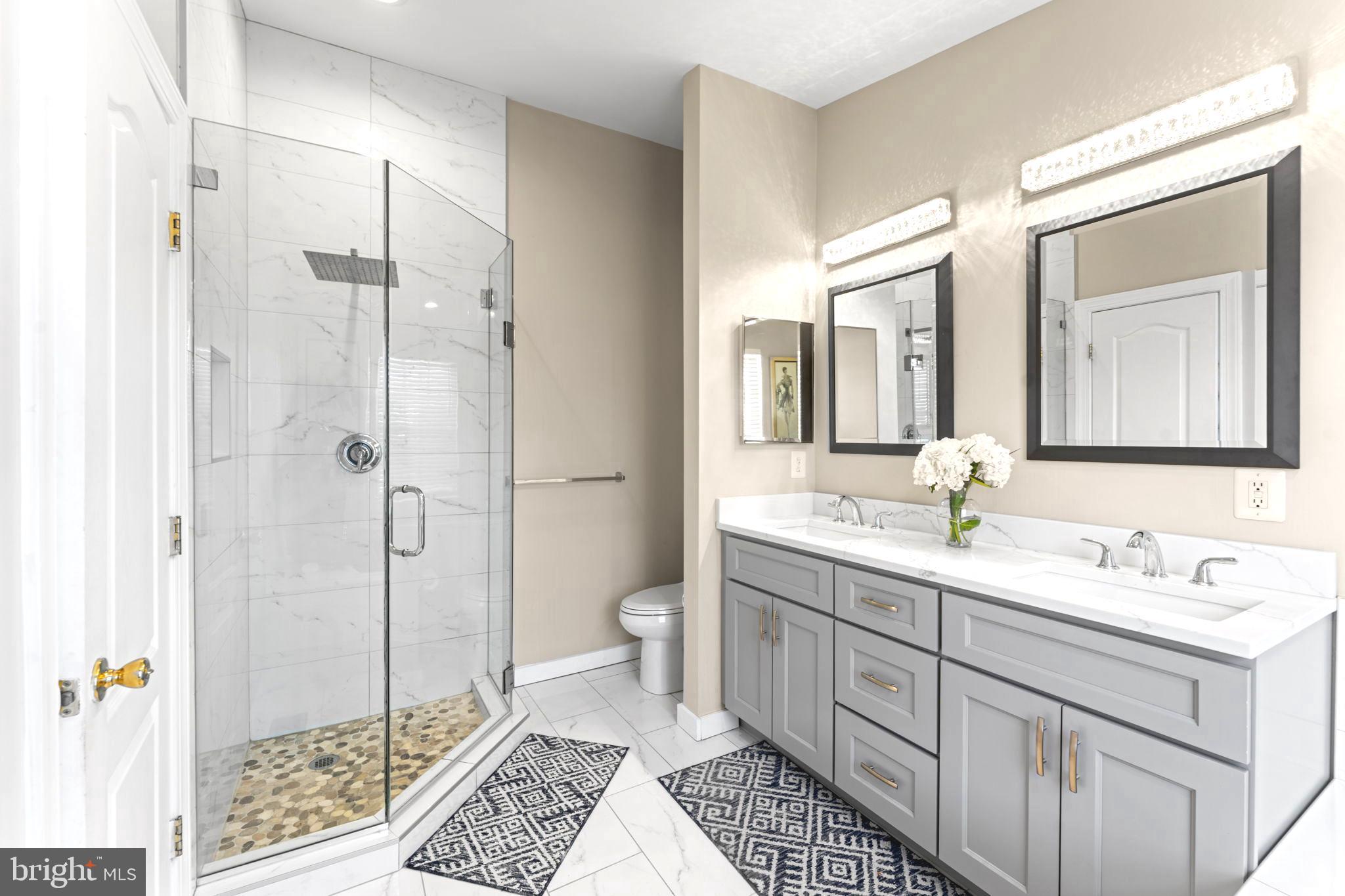 75 Swanton Lane, Unit 200 Gaithersburg, MD 20878 - Photo 18 of 54 a spacious bathroom with a double vanity sink mirror and toilet