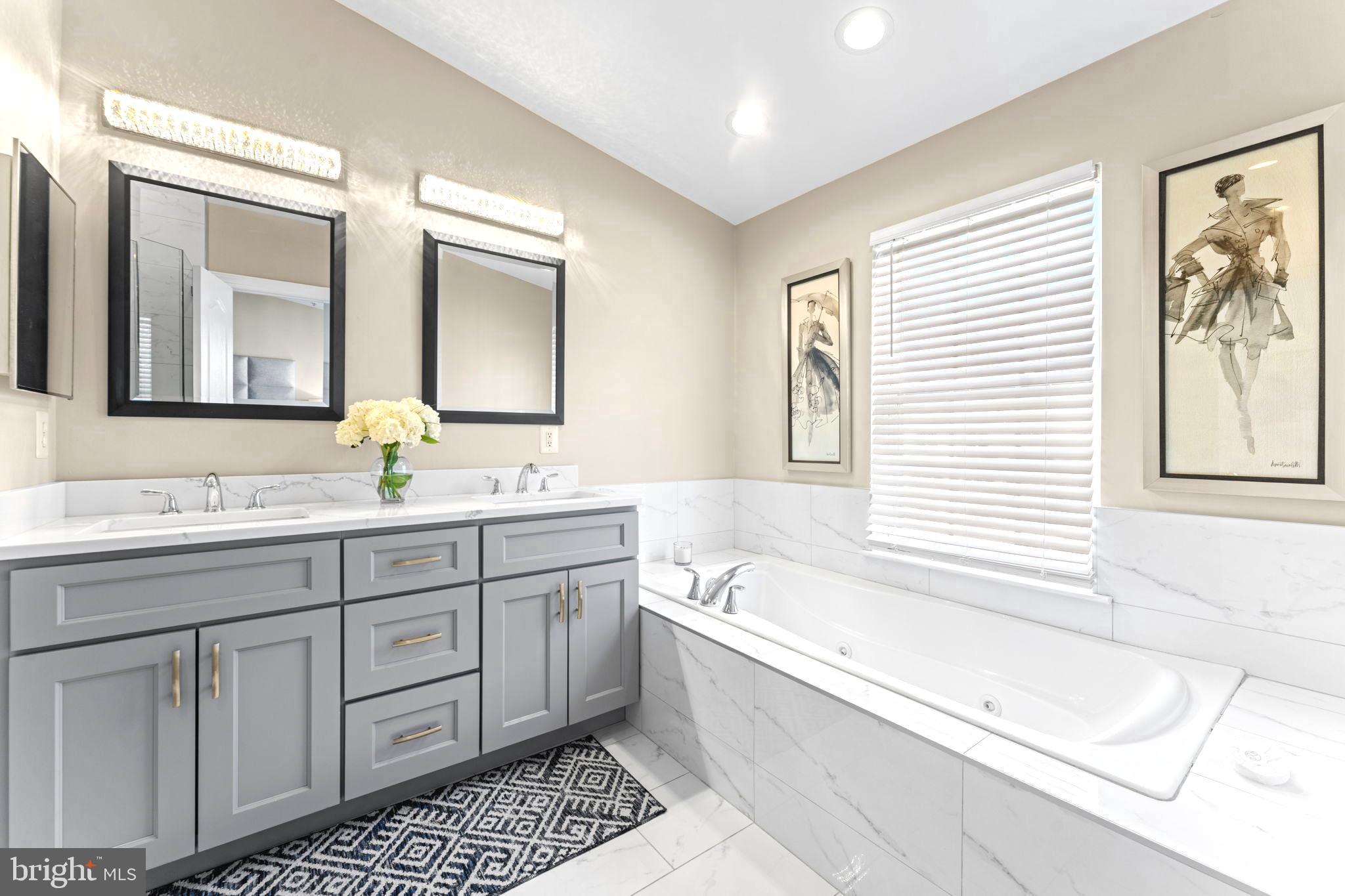 75 Swanton Lane, Unit 200 Gaithersburg, MD 20878 - Photo 19 of 54 a bathroom with a tub a sink and a large mirror