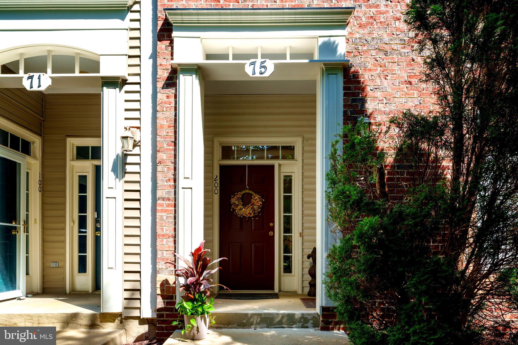 75 Swanton Lane, Unit 200 Gaithersburg, MD 20878 - Photo 26 of 54 a front view of a building with potted plants