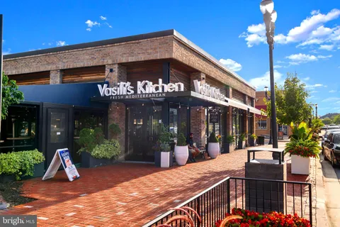 a view of a cars park in front of a building