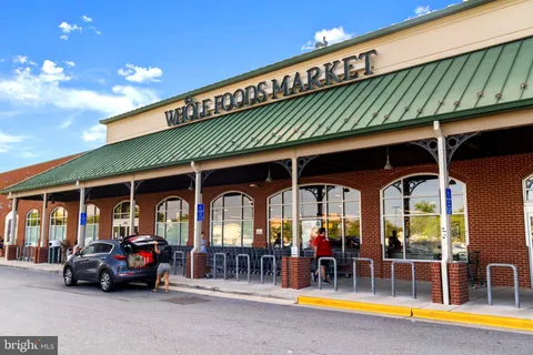 a view of a brick building with a bench in front of building