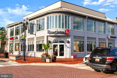 a view of a building with a street and trees