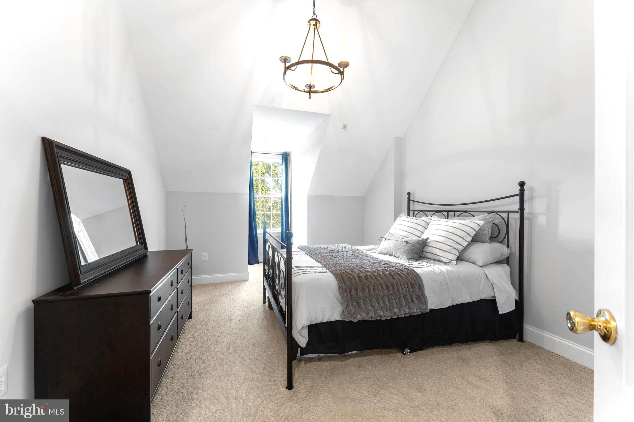 75 Swanton Lane, Unit 200 Gaithersburg, MD 20878 - Photo 10 of 54 a spacious bedroom with a bed a window and dresser