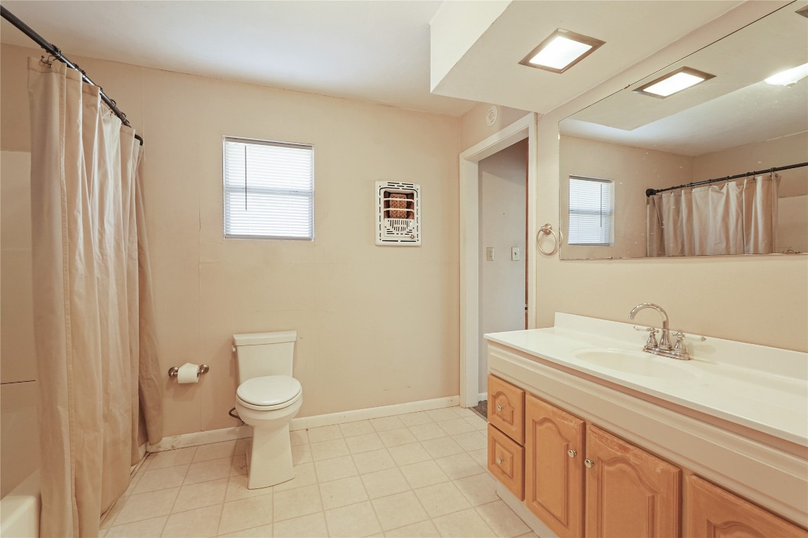 6407 Pleak Road Richmond, TX 77469 - Photo 16 of 22 a bathroom with a toilet sink and mirror
