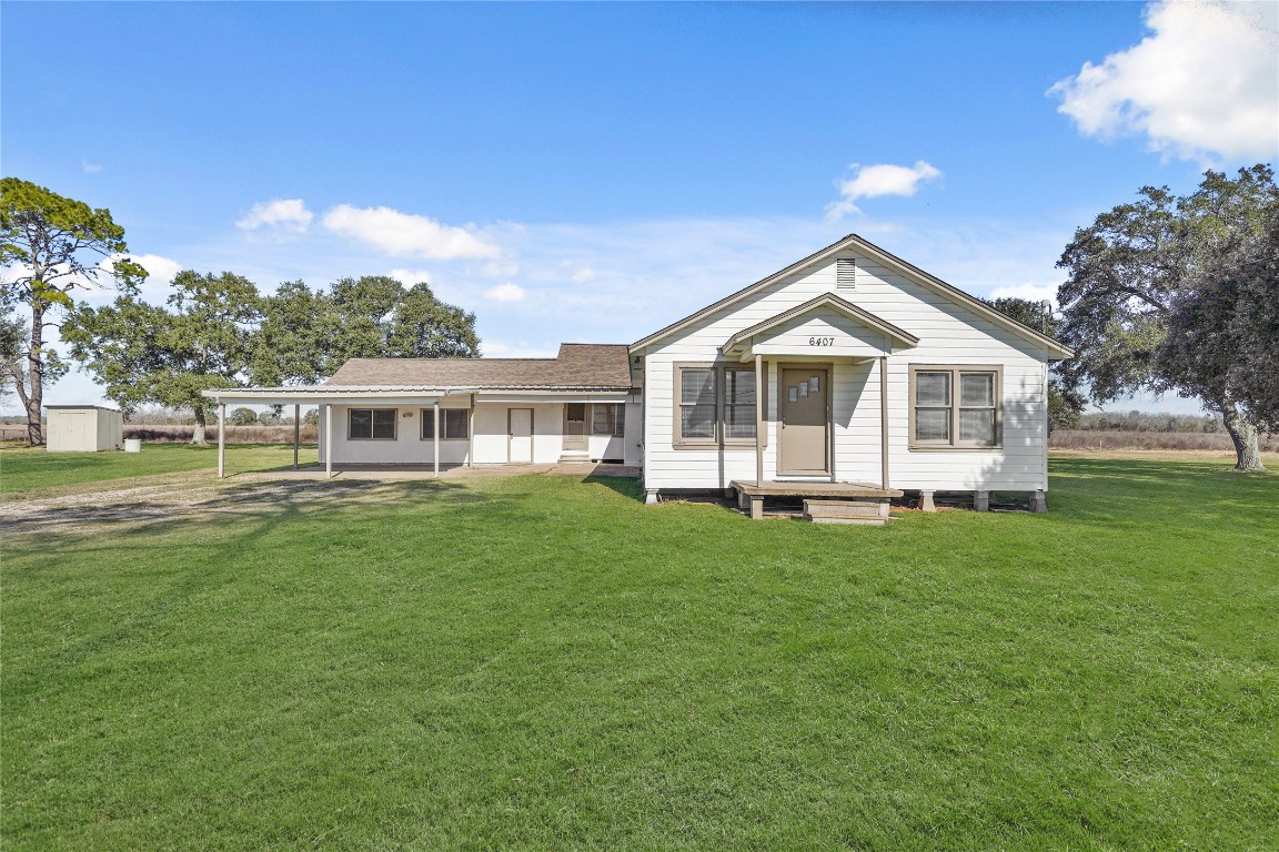 6407 Pleak Road Richmond, TX 77469 - Photo 2 of 22 a front view of a house with a garden