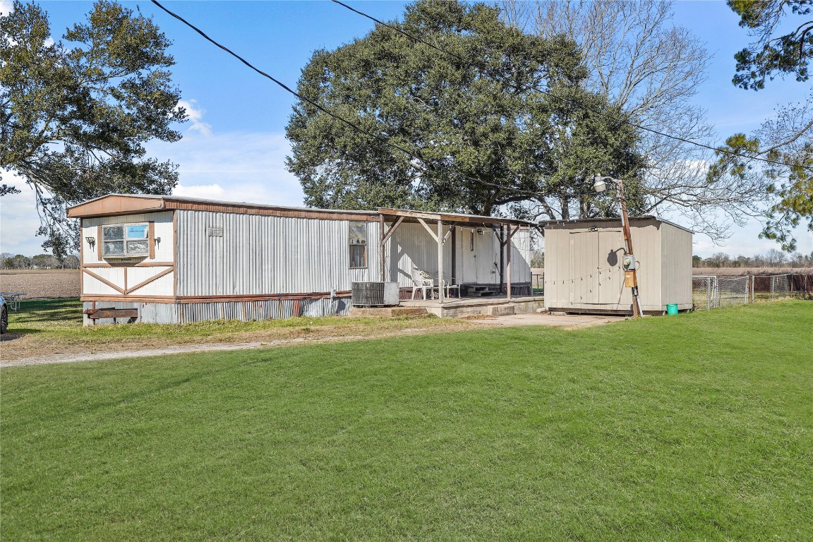 6407 Pleak Road Richmond, TX 77469 - Photo 22 of 22 a view of a backyard with large trees and a small yard