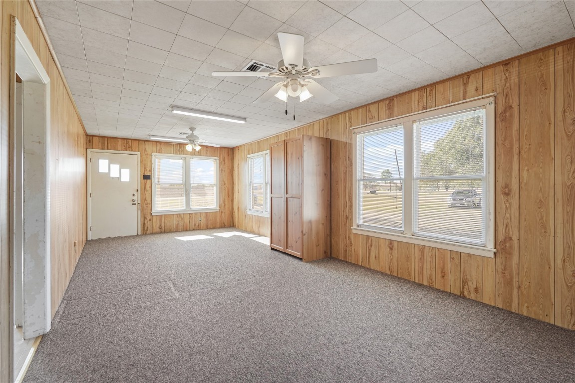 6407 Pleak Road Richmond, TX 77469 - Photo 6 of 22 an empty room with windows and chandelier fan