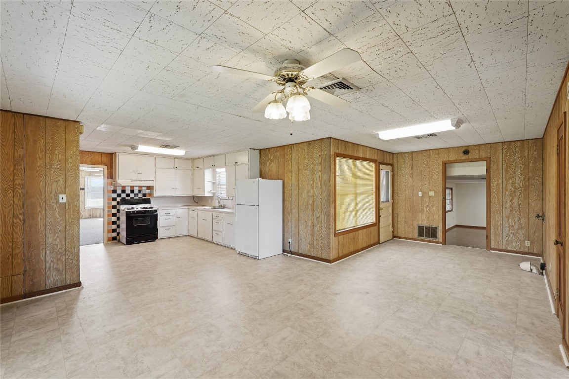 6407 Pleak Road Richmond, TX 77469 - Photo 9 of 22 a view of a livingroom with a chandelier fan and kitchen view