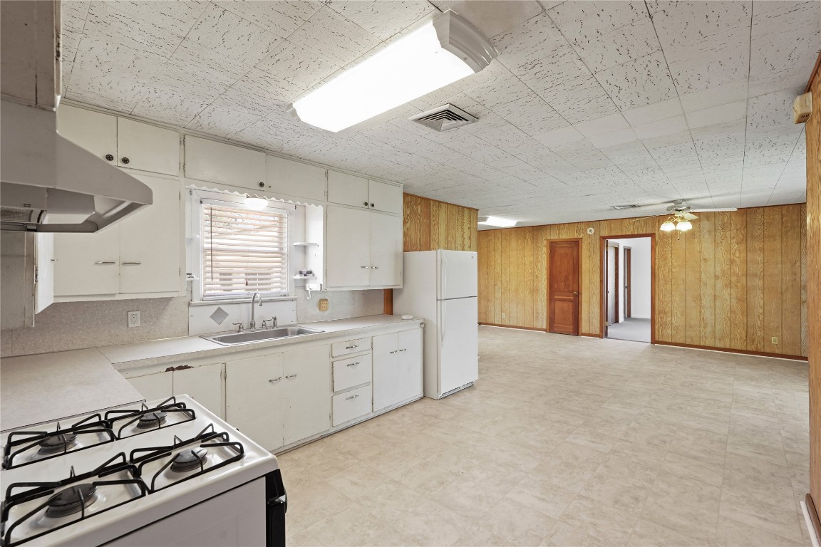 6407 Pleak Road Richmond, TX 77469 - Photo 10 of 22 a kitchen with granite countertop a sink stove and cabinets