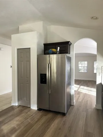 a view of a refrigerator in kitchen and wooden floor