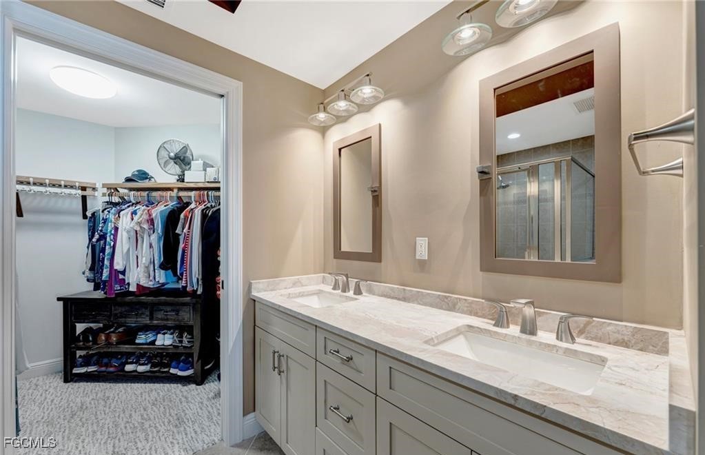 2745 First Street, Unit 2602 Fort Myers, FL 33916 - Photo 11 of 29 a bathroom with a sink and a mirror