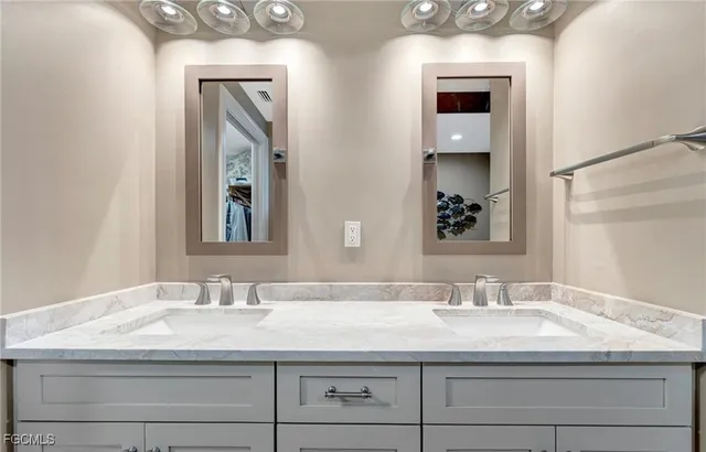 a bathroom with sinks granite vanity and a mirror