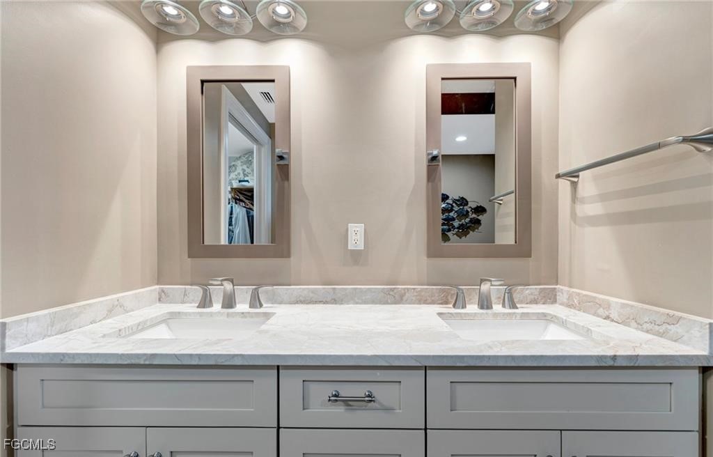 2745 First Street, Unit 2602 Fort Myers, FL 33916 - Photo 13 of 29 a bathroom with sinks granite vanity and a mirror