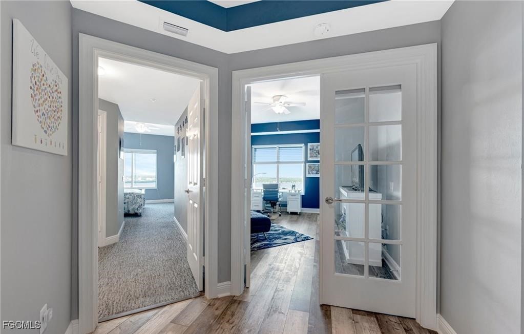 2745 First Street, Unit 2602 Fort Myers, FL 33916 - Photo 17 of 29 a view of a hallway with wooden floor windows and a livingroom