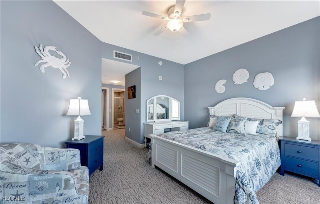 2745 First Street, Unit 2602 Fort Myers, FL 33916 - Photo 18 of 29 a bedroom with a bed and a chandelier