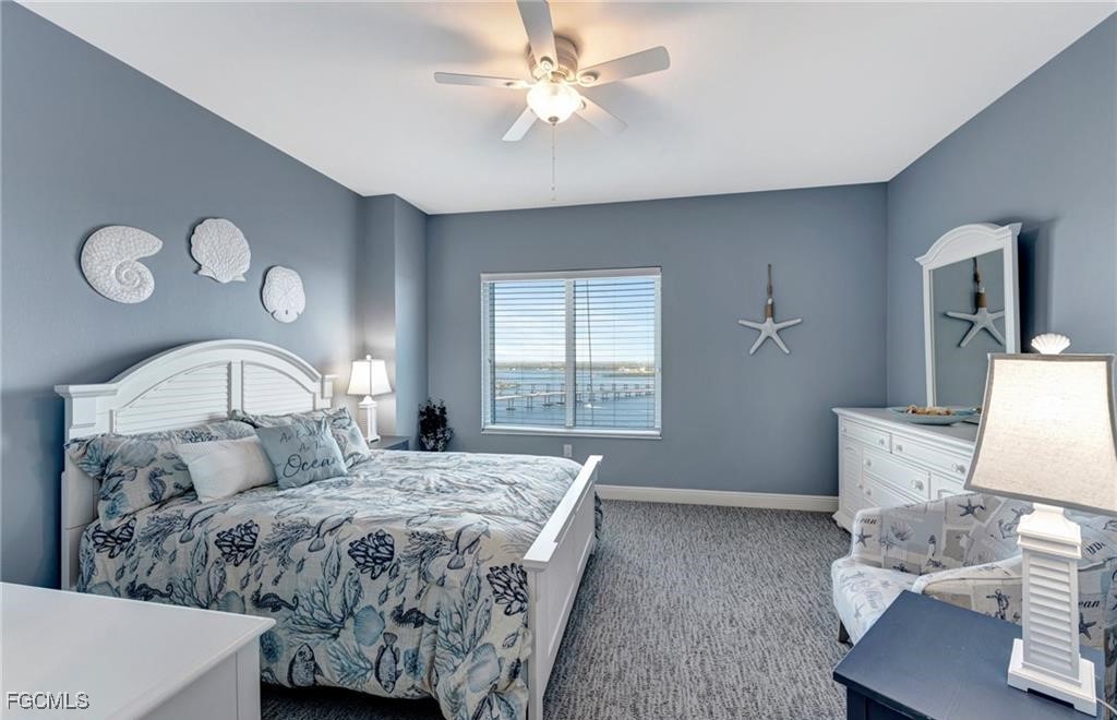 2745 First Street, Unit 2602 Fort Myers, FL 33916 - Photo 19 of 29 a bedroom with a large bed and a chandelier