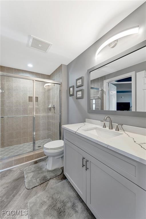 2745 First Street, Unit 2602 Fort Myers, FL 33916 - Photo 20 of 29 a bathroom with a granite countertop sink toilet a large mirror a shower and vanity