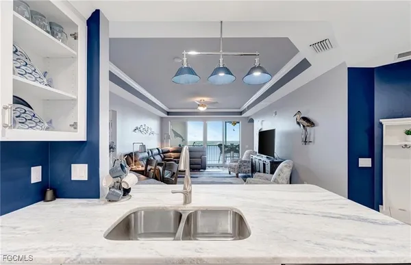 a view of a room with a chandelier furniture and windows