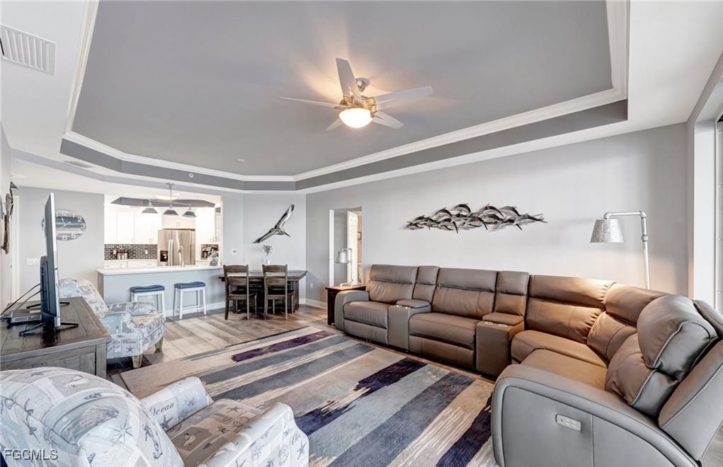 2745 First Street, Unit 2602 Fort Myers, FL 33916 - Photo 7 of 29 a living room with furniture ceiling fan and a rug