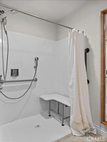 a bathroom with a double vanity sink mirror and shower