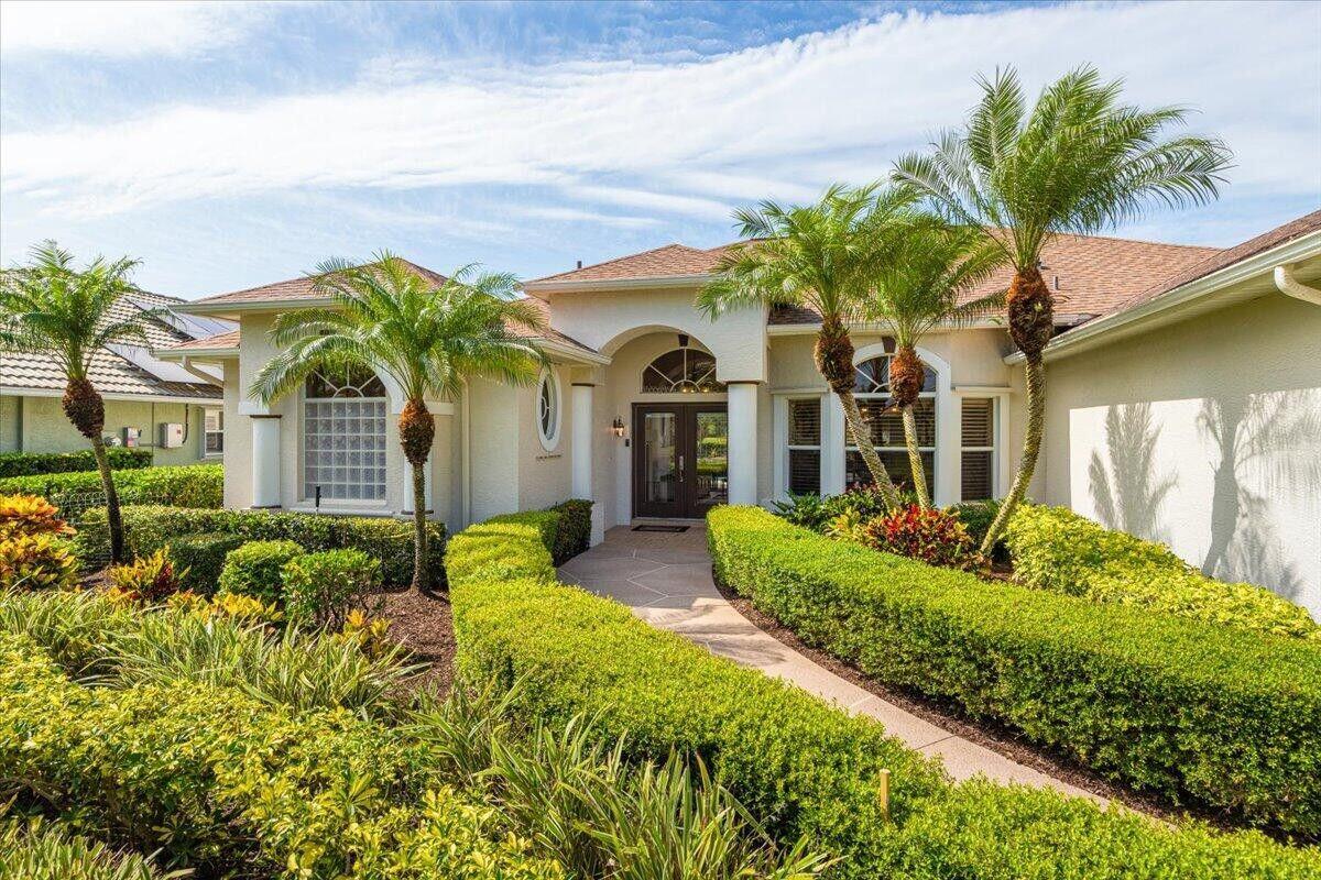 212 Southwest Whitewood Drive Port St. Lucie, FL 34953 - Photo 1 of 26 a front view of a house with garden