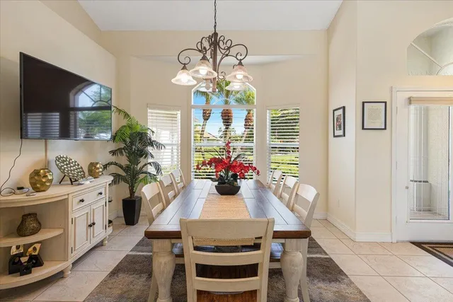 a view of a dining room with furniture a livingroom and chandelier
