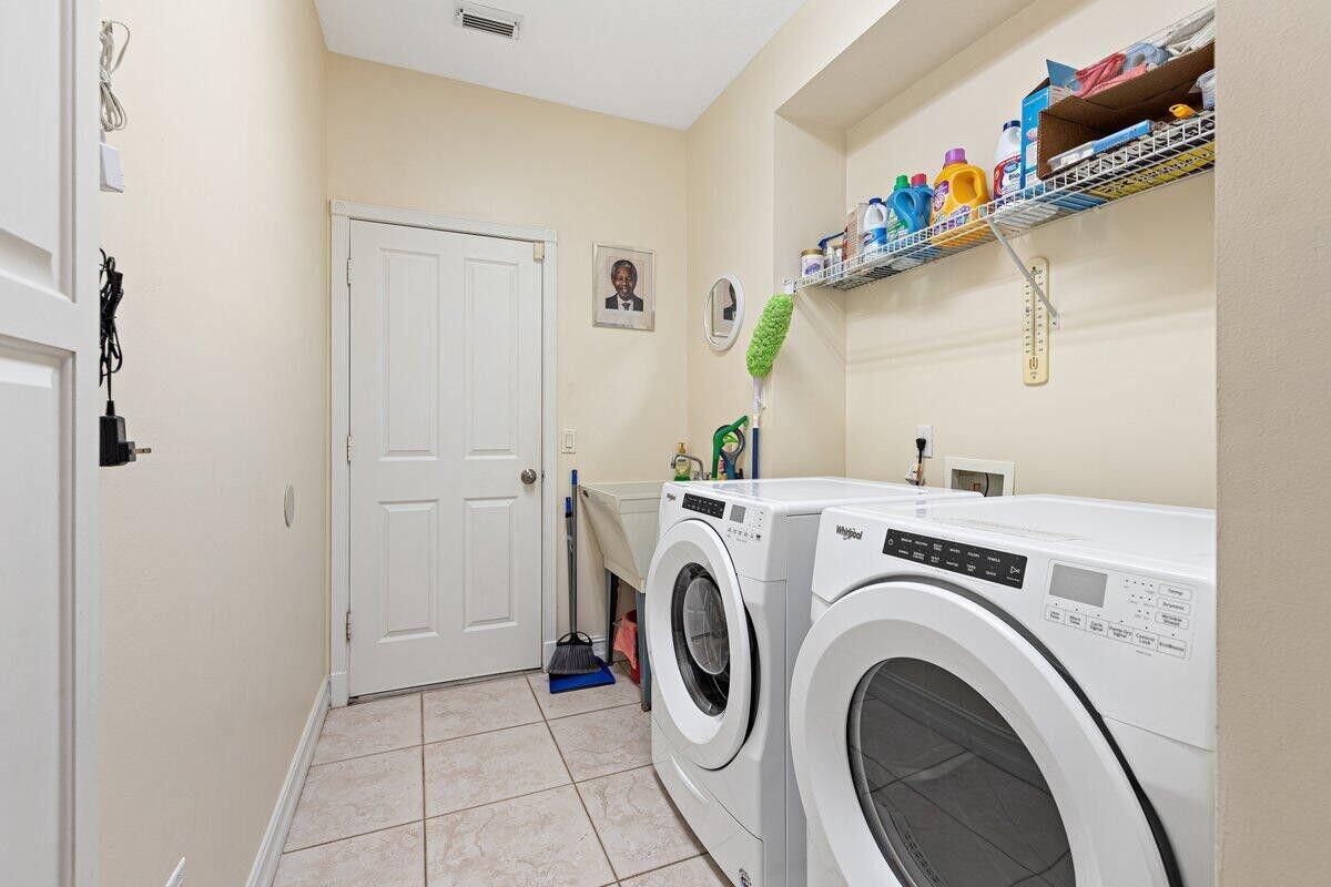 212 Southwest Whitewood Drive Port St. Lucie, FL 34953 - Photo 19 of 26 a utility room with dryer and washer