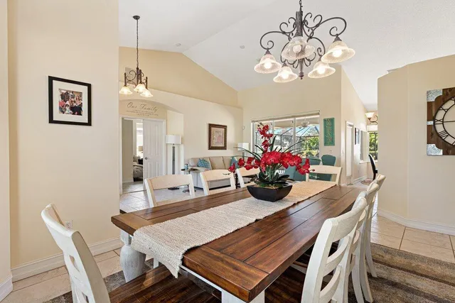 a view of a dining room with furniture wooden floor and chandelier