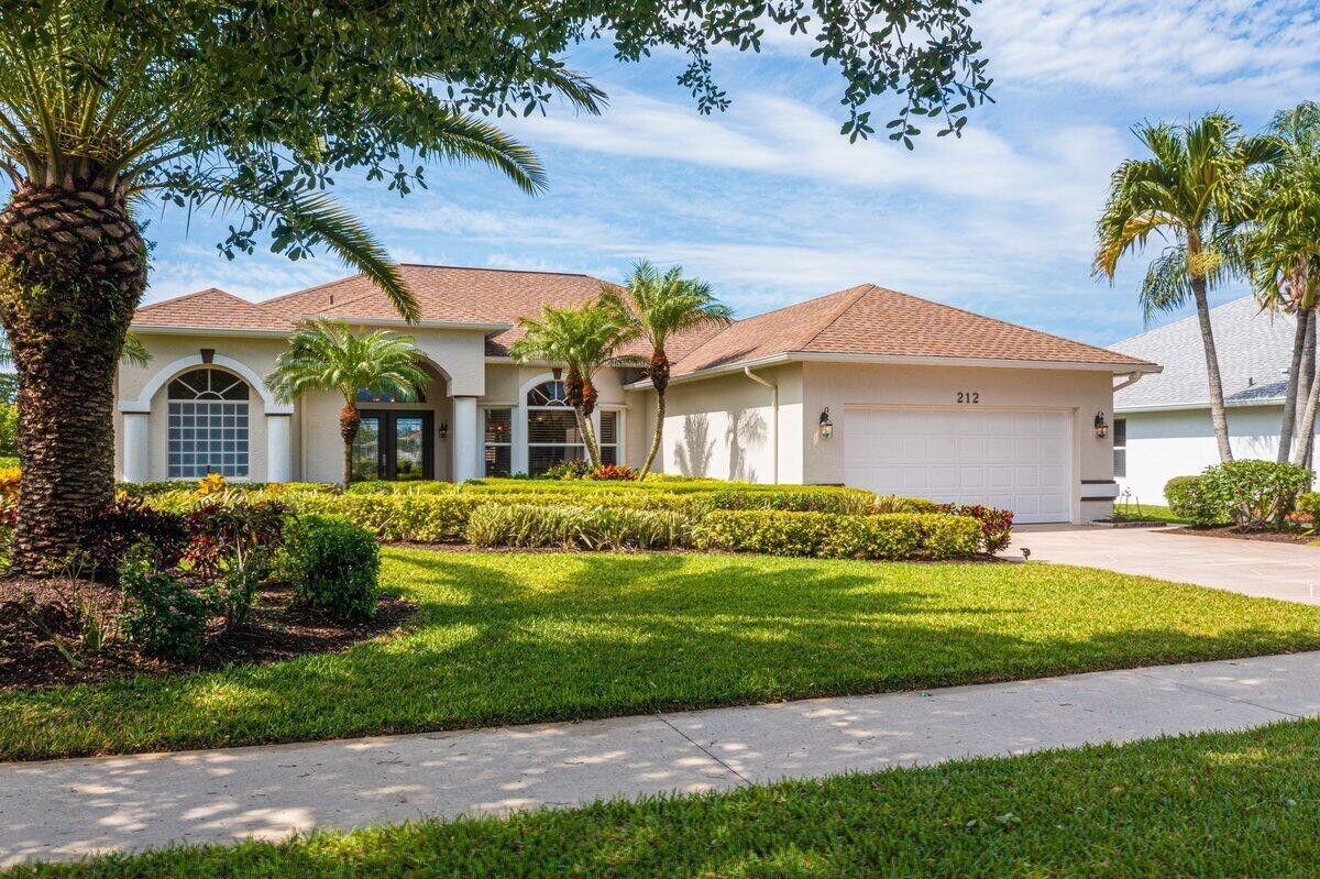 212 Southwest Whitewood Drive Port St. Lucie, FL 34953 - Photo 22 of 26 a front view of a house with a garden
