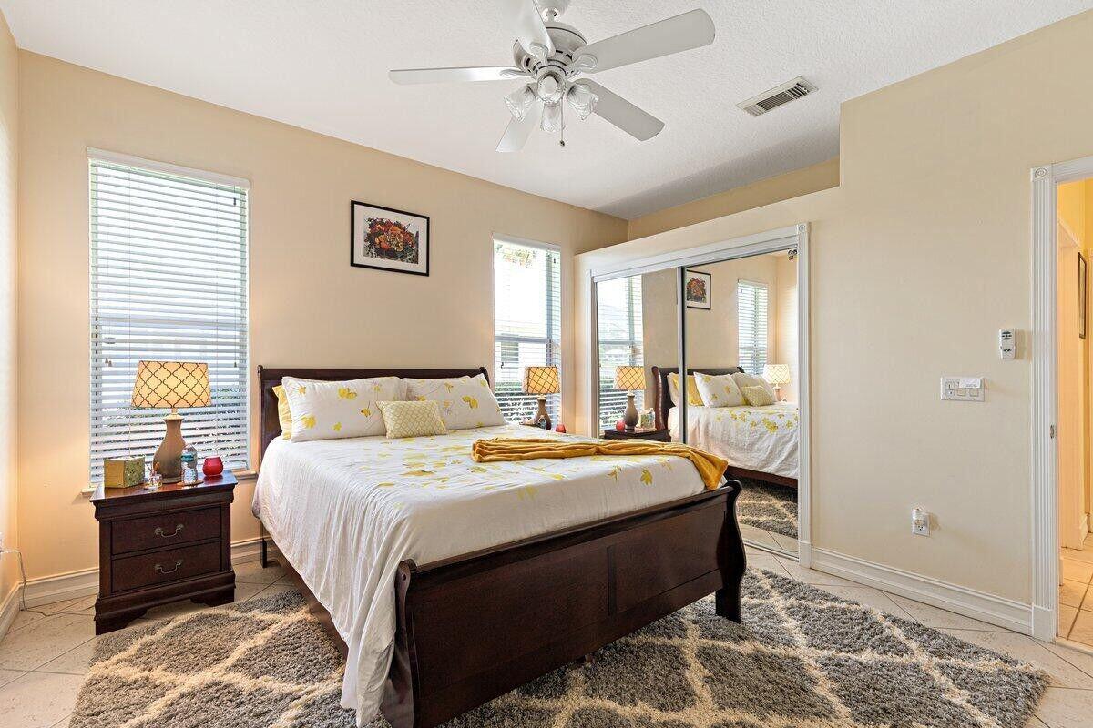 212 Southwest Whitewood Drive Port St. Lucie, FL 34953 - Photo 26 of 26 a bedroom with bed and a window