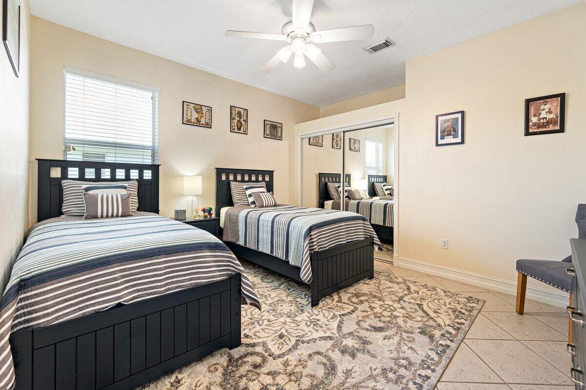 212 Southwest Whitewood Drive Port St. Lucie, FL 34953 - Photo 8 of 26 a bedroom with two beds and a window