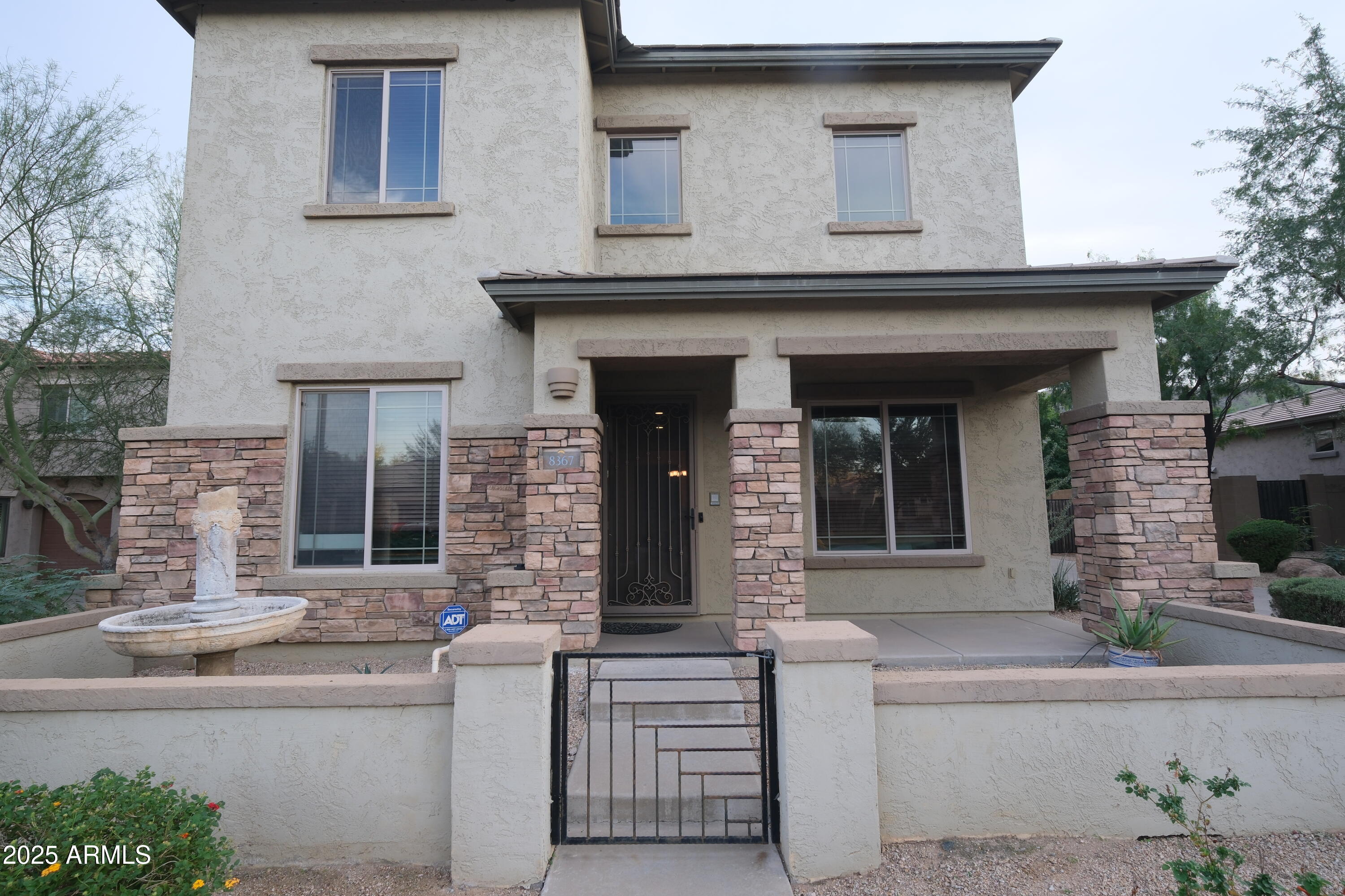 8367 West Briles Road Peoria, AZ 85383 - Photo 2 of 30 a front view of a house with large windows