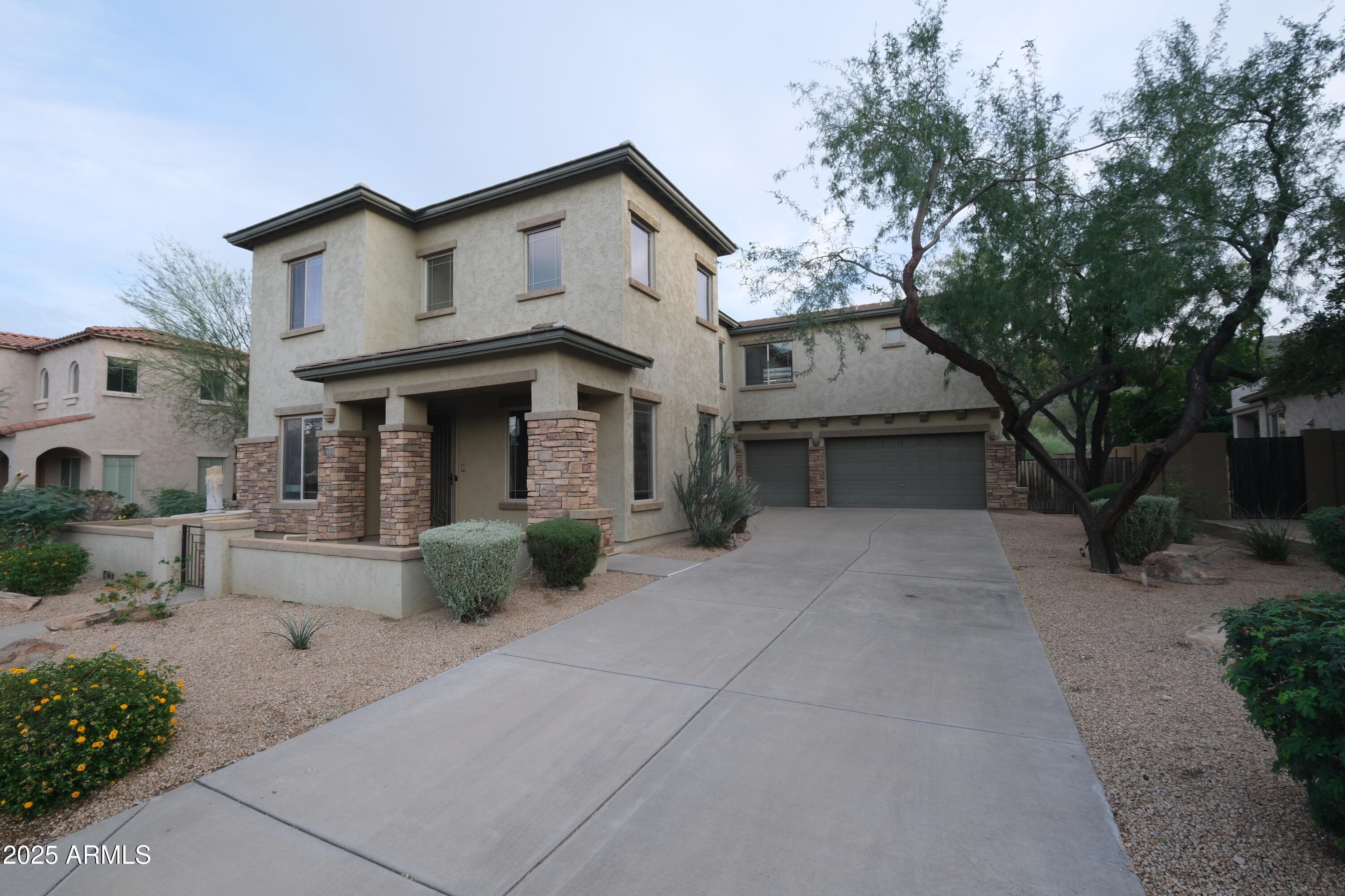 8367 West Briles Road Peoria, AZ 85383 - Photo 3 of 30 a front view of a house with garden
