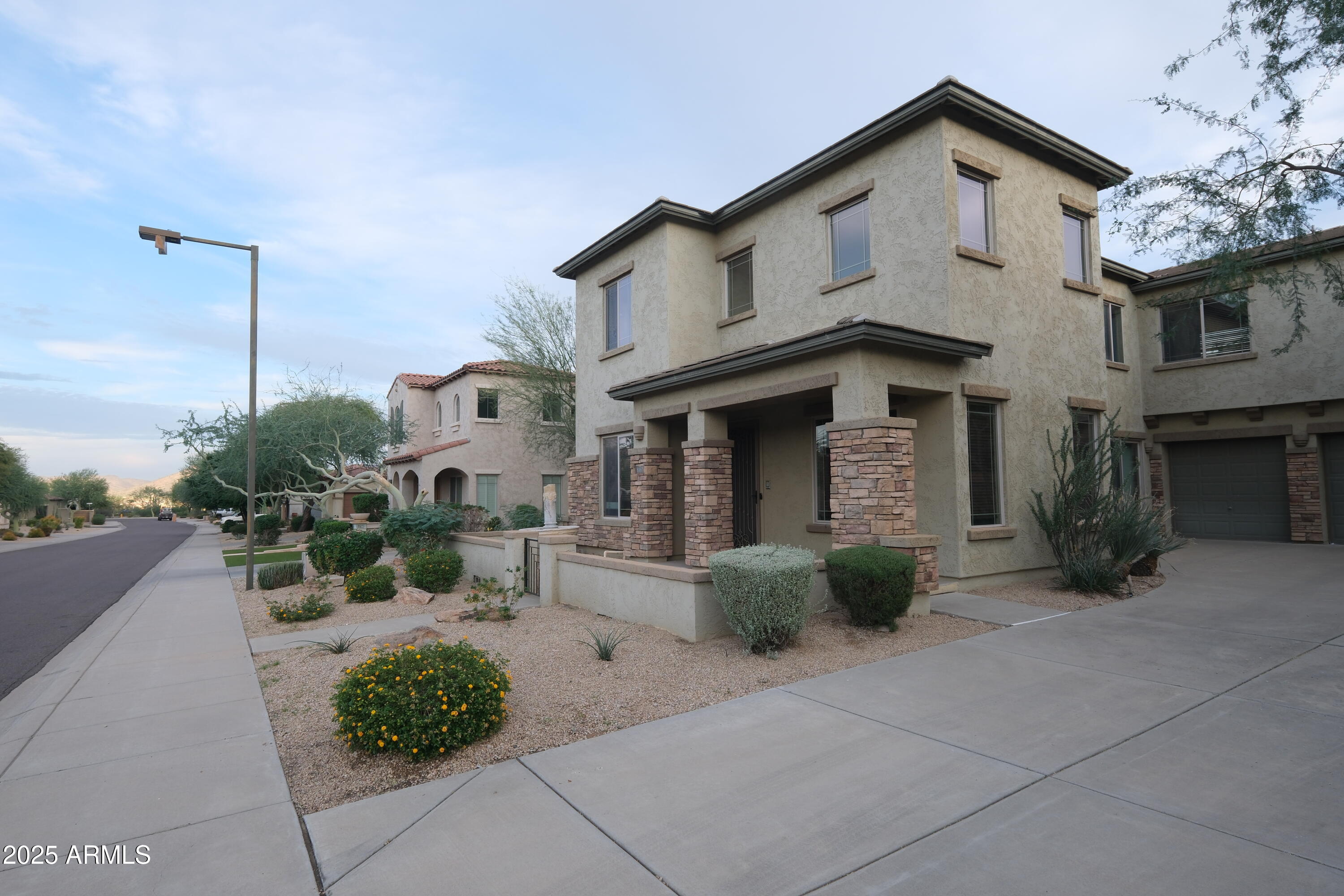 8367 West Briles Road Peoria, AZ 85383 - Photo 5 of 30 a front view of a house with garden
