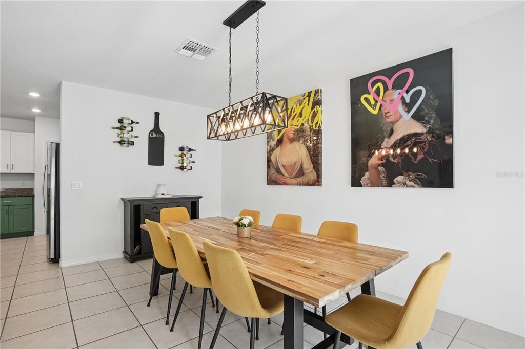 1718 Red Loop Lakeland, FL 33801 - Photo 16 of 25 a dining room with furniture and painting on the wall