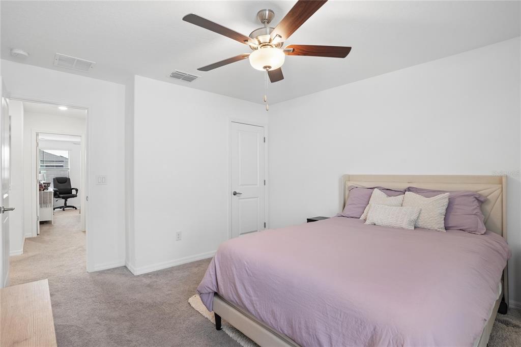 1718 Red Loop Lakeland, FL 33801 - Photo 22 of 25 a bedroom with a bed and a ceiling fan