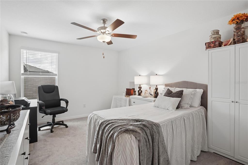1718 Red Loop Lakeland, FL 33801 - Photo 23 of 25 a bedroom with a bed and a chandelier