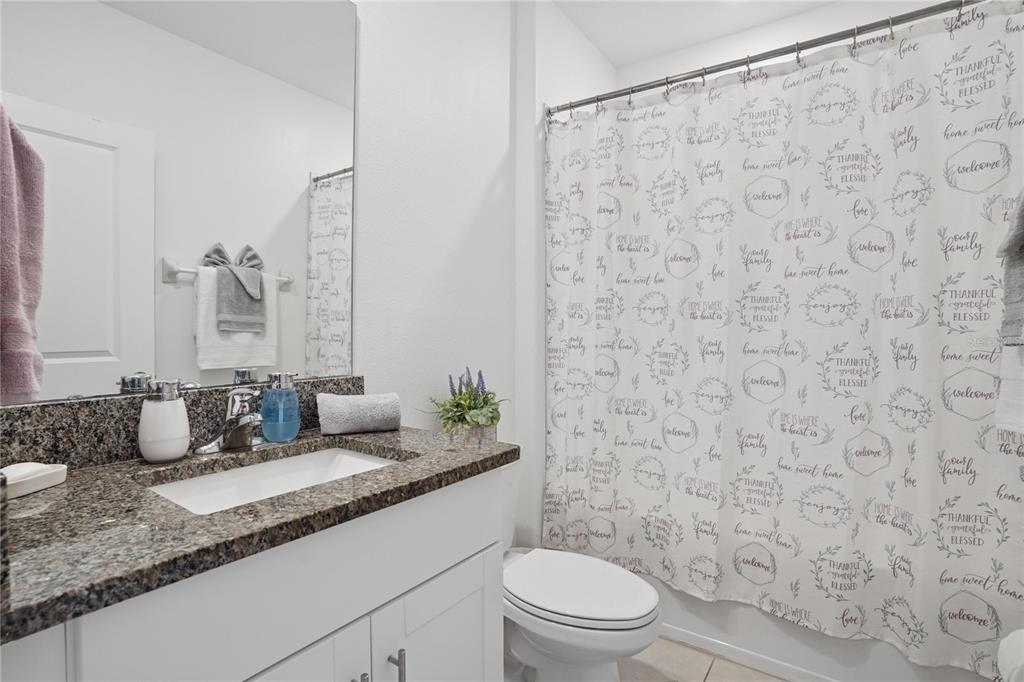 1718 Red Loop Lakeland, FL 33801 - Photo 3 of 25 a bathroom with a granite countertop sink and a mirror
