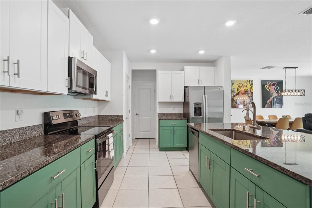 1718 Red Loop Lakeland, FL 33801 - Photo 10 of 25 a kitchen with stainless steel appliances granite countertop a sink stove and refrigerator
