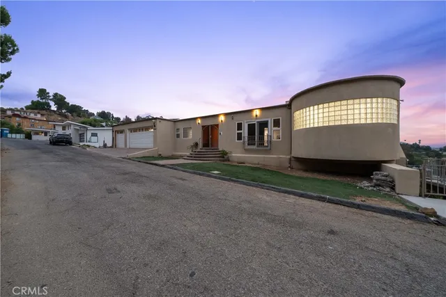 a kitchen with granite countertop a stove and a wooden floors